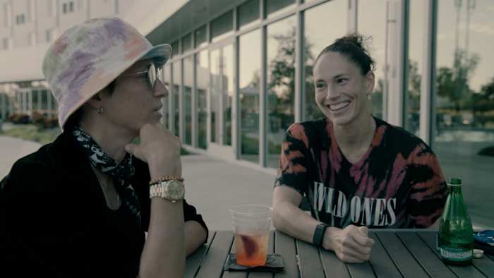 Megan Rapinoe and Sue Bird sitting at a table